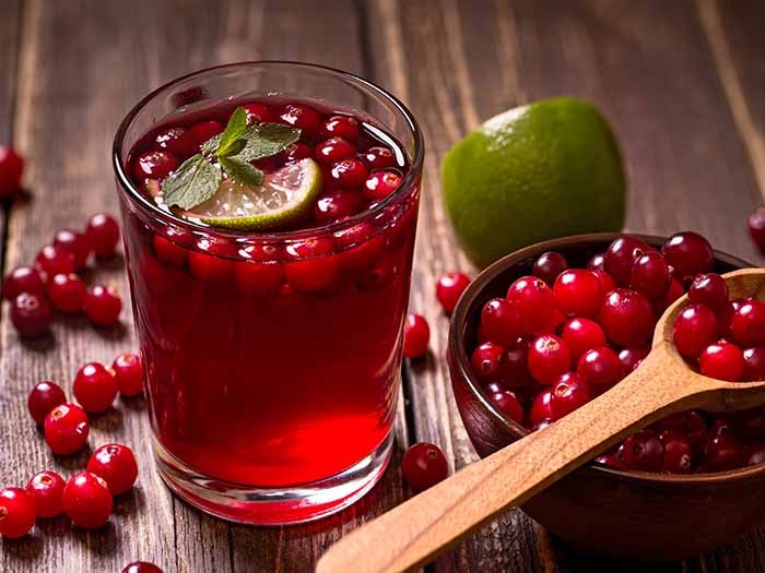 cranberry juice with lime and fresh cranberries in a bowl on a